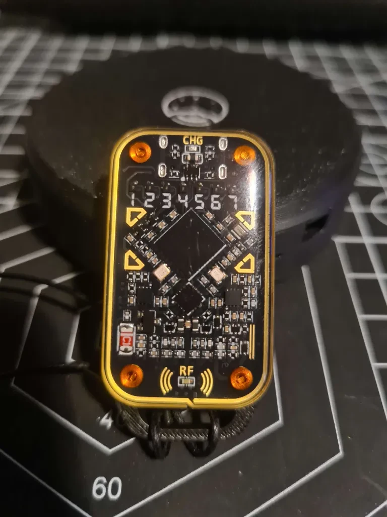Circuit-board side of a black and yellow Chameleon Ultra with its components visible