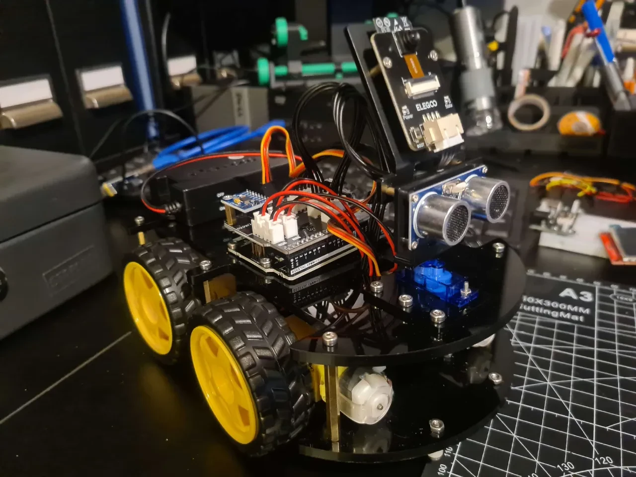 ELEGOO four-wheel robot car with ultrasonic sensors, camera, circuit boards and exposed wiring