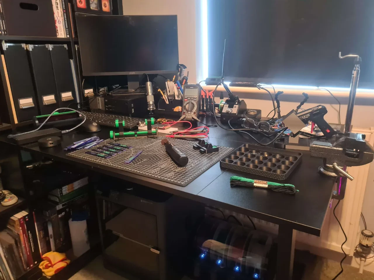 Electronics and lock-picking workbench with tools, test equipment, cutting mat and parts storage