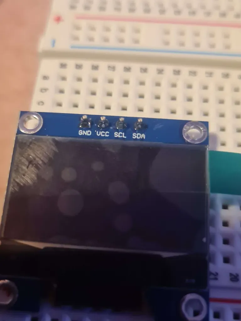 Close-up of the SSD1306 OLED showing its GND, VCC, SCL and SDA connection labels